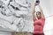 Low angle view of dedicated woman lifting kettlebell in crossfit gym