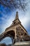 Low angle view Eiffel Tower and passing clouds, Paris, France