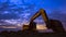 Low angle view of excavator working to land leveling in construction site against sunset sky