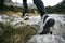 Low angle view of female hiking shoes stepping on rocky mountain trail