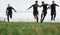 Low angle view of footballers playing on the field running for the ball. Group of men running for possession of ball while playing