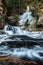 Low angle view of a frozen waterfall surrounded by trees