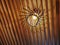 Low Angle View of Hanging Illuminated Light Bulb on Wooden Planks Ceiling