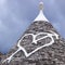Low angle view of a heart shape painted on a trulli house