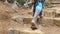 Low angle view of indian female feet going up of ancient stone stair at hill. Following to local unrecognizable woman