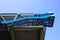 Low angle view on industrial modern building with open blue stairways against heaven