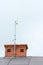 Low angle view of a internet antenna fixed to the chimney on the tile roof