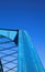 Low angle view on isolated symmetrical industrial steel bridge deck against blue sky with cross struts and metal beam with nutches