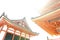 Low angle view of Japanese architecture buildings and roof details of pagoda against white sky at a Buddhist temple in Kyoto, Japa