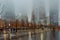 Low Angle View of Lower Manhattan Skyscrapers on a Foggy Night. Buildings Fading into the Fog