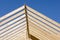 Low angle view of a lumber construction under a blue sky and sunlight at daytime