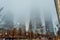 Low Angle View of Manhattan Freedom Tower and other Skyscrapers on a Foggy Night in New York. Buildings Fading into the Fog