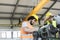 Low angle view of manual workers working on machinery in metal industry