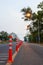 A low-angle view of many reflective orange plastic poles set up as a sign to prevent oncoming traffic