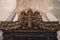 Low-angle view of medieval pipe organs under the patterned white ceiling