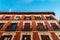 Low angle view of old recently renovated residential building against blue sky