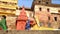 Low angle view of people passing by street buildings in Varanasi.