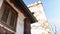 Low-angle view of rustic building under blue sky