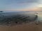 Low angle view from sandy beach to coming waves from the ocean