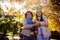 Low angle view of siblings holding umbrella in park