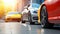 Low angle view of sleek cars parked on a city street, with the focus on the red car's alloy wheel, showcasing urban