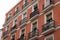 Low angle view of small balconies residential building facade in Madrid