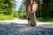 Low angle view of a sole of a shoe of caucasian female walking on pa path in the forest