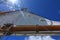 A low angle view of a tall ship sail against a bright blue sky taken looking up from the deck of the boat