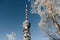 Low angle view of tall tv tower above snowy trees in winter at Sljeme near Zagreb, Croatia