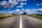 Low angle view of a tarred road receding