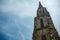 Low angle view of tower of Bern Munster on cloudy blue sky background