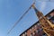 Low angle view under yellow tower cranes.