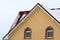 Low angle view of the upper floors of a new large house. Window and roof detail of residential home building. Real estate property