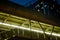 Low angle view of walkway overpass and condominium in the night.