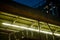 Low angle view of walkway overpass and condominium in the night.