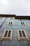 Low angle view of the windows on the old building in San Quirico in Tuscany