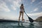 Low angle view of woman paddleboarding
