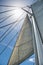 Low angle view of yacht sails and mast against sky