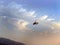 Low angle view of yellow color Gyrocopter flying in the blue sky and dramatic clouds, fun fly, aero sports, skydive, Roto craft,