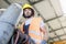 Low angle view of young manual worker moving gas cylinder in metal industry