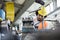 Low angle view of young manual worker working on machinery in metal industry