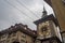 Low angle view of The Zytglogge is a landmark clock tower in Bern on cloudy sky background