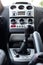 Low angle wide view of generic car middle console dashboard visible manual gearbox lever