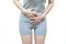 Low body of a woman in gray clothes put her hands on the Stomach area at spot of ache, abdominal pain, Health-care concept on