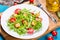 Low-calories salad with chicken breast, arugula and tomatoes