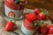 Low Carb Strawberry and chia puddings in a glass, wood background