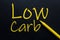 Low Carb Yellow Pen with yellow text own rent at the black background