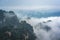 Low clouds engulfing stone pillars of Tianzi mountains in Zhangjiajie