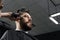 Low fade machine haircut for handsome bearded man in barbershop. Barber with dread locks making hairstyle with a smooth
