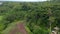 Low flying aerial dolly shot of a luxury resort villas hidden in the dense green rainforests of Bali